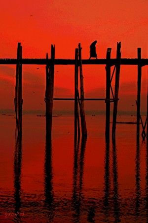 Monk crossing U-Bein bridge